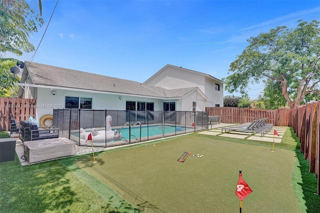 614 SE 12th Ave, Deerfield Beach, FL 33441 - view of swimming pool featuring an area to practice putting, a fenced backyard, and a patio area