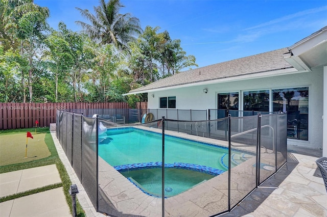 614 SE 12th Ave, Deerfield Beach, FL 33441 - view of swimming pool with a putting area, a pool with connected hot tub, a patio, and a fenced backyard