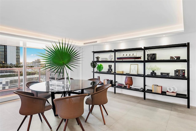 2301 Collins Ave Unit 1004/1003, Miami Beach, FL 33139 - dining room featuring a raised ceiling and light tile patterned floors