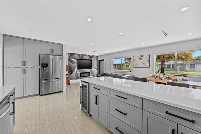 8115 NW 185th Ter, Hialeah, FL 33015 - kitchen with stainless steel appliances, gray cabinetry, wine cooler, light countertops, and recessed lighting