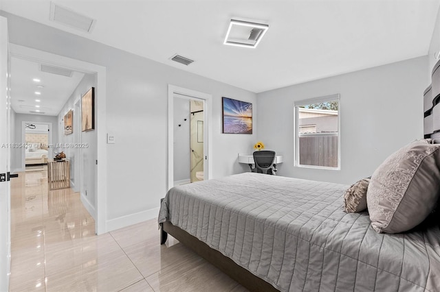 8115 NW 185th Ter, Hialeah, FL 33015 - bedroom featuring multiple windows, light tile patterned floors, and connected bathroom