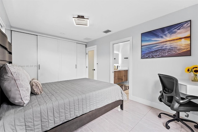 8115 NW 185th Ter, Hialeah, FL 33015 - bedroom featuring an office area, ensuite bathroom, a closet, and light tile patterned floors