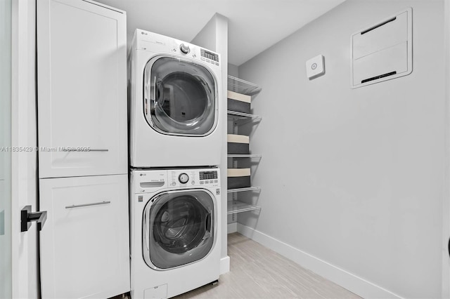 8115 NW 185th Ter, Hialeah, FL 33015 - laundry room with estacked washer and dryer and wood finished floors