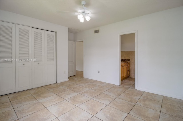 9443 SW 174th St Unit 9443, Palmetto Bay, FL 33157 - unfurnished bedroom with a closet, light tile patterned floors, a ceiling fan, and ensuite bathroom