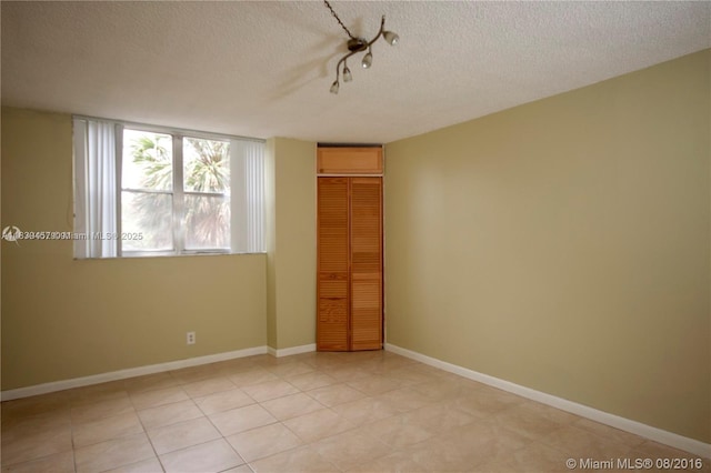 2821 N Miami Beach Blvd Unit 2E, North Miami Beach, FL 33160 - unfurnished room with a textured ceiling and baseboards