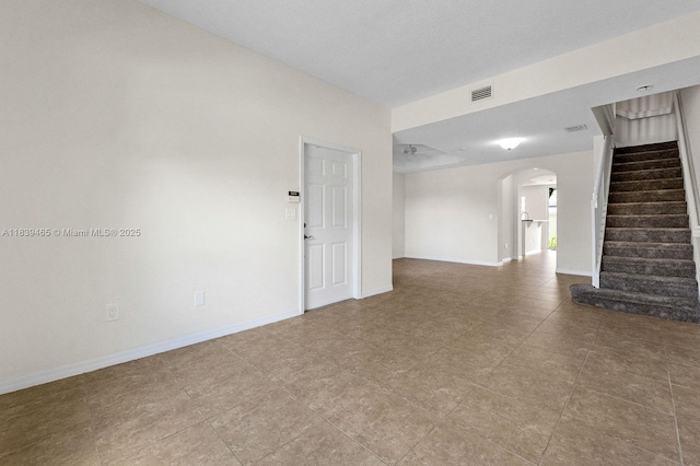 3066 S Red Mangrove Ln S Unit 201-2, Dania Beach, FL 33312 - unfurnished living room with arched walkways, stairs, and tile patterned floors