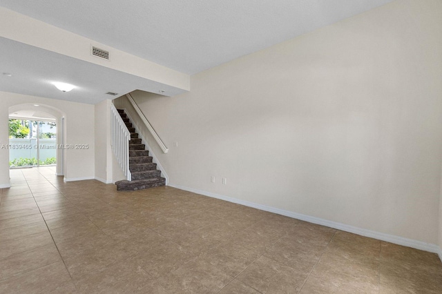 3066 S Red Mangrove Ln S Unit 201-2, Dania Beach, FL 33312 - unfurnished living room featuring stairway and arched walkways
