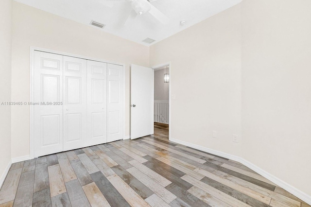 3066 S Red Mangrove Ln S Unit 201-2, Dania Beach, FL 33312 - unfurnished bedroom with wood finished floors, a closet, and a ceiling fan
