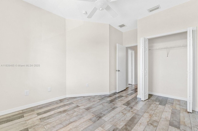 3066 S Red Mangrove Ln S Unit 201-2, Dania Beach, FL 33312 - unfurnished bedroom with light wood-type flooring, ceiling fan, and a closet