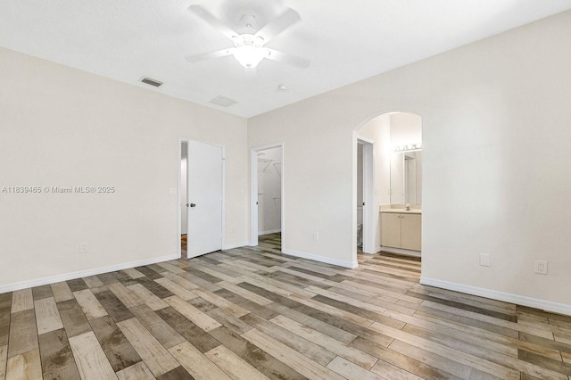 3066 S Red Mangrove Ln S Unit 201-2, Dania Beach, FL 33312 - spare room featuring arched walkways, ceiling fan, and light wood-type flooring