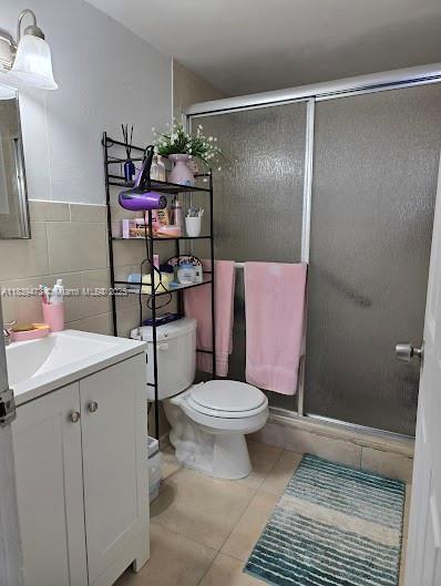 5755 W 20th Ave Unit 206, Hialeah, FL 33012 - full bath featuring vanity, tile patterned flooring, a shower stall, and tile walls