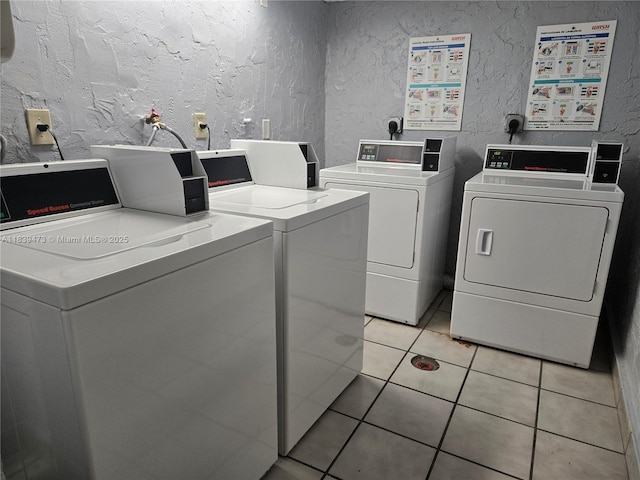 5755 W 20th Ave Unit 206, Hialeah, FL 33012 - community laundry with washer and clothes dryer, a textured wall, and light tile patterned flooring
