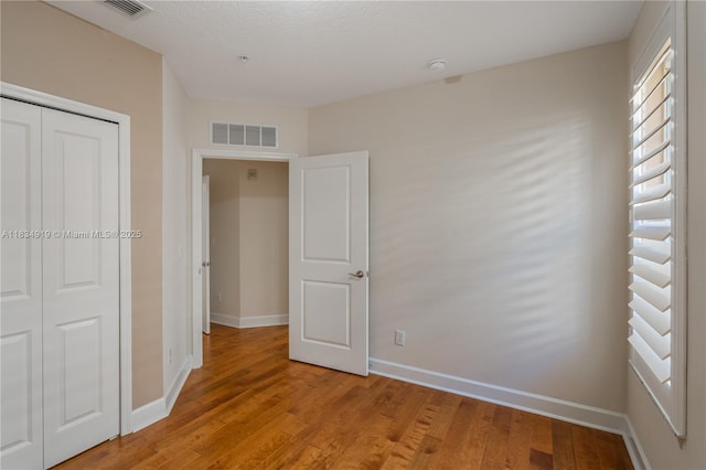 1231 Wright Cir Unit 108, Kissimmee, FL 34747 - unfurnished bedroom with light wood finished floors and a closet