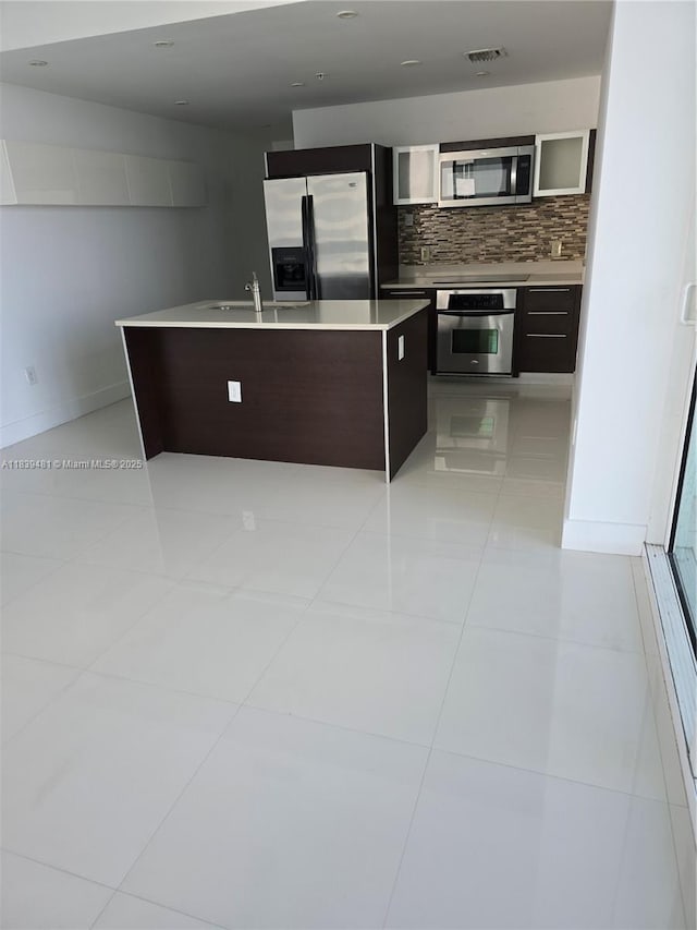1900 N Bayshore Dr Unit 1803, Miami, FL 33132 - kitchen with appliances with stainless steel finishes, tasteful backsplash, light countertops, and light tile patterned floors