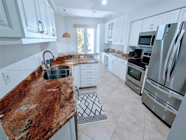 1900 Oceanwalk Ln Unit 123, Lauderdale By The Sea, FL 33062 - kitchen with appliances with stainless steel finishes, white cabinets, a peninsula, and dark stone counters