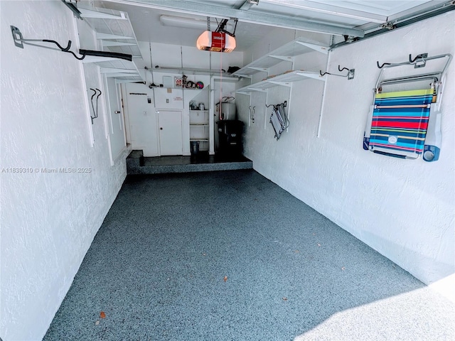 1900 Oceanwalk Ln Unit 123, Lauderdale By The Sea, FL 33062 - garage with a textured wall and a garage door opener