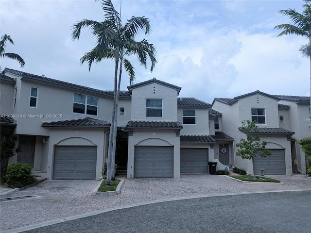 1900 Oceanwalk Ln Unit 123, Lauderdale By The Sea, FL 33062 - mediterranean / spanish house with a garage, driveway, stucco siding, and a tiled roof