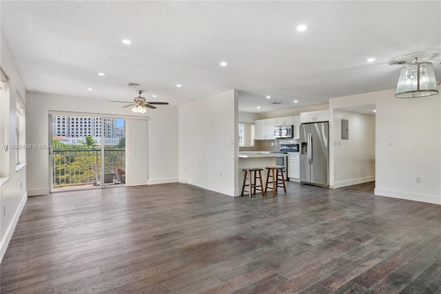 37 Majorca Ave Unit 401, Coral Gables, FL 33134 - unfurnished living room with a textured ceiling, healthy amount of natural light, dark wood-style floors, recessed lighting, and electric panel