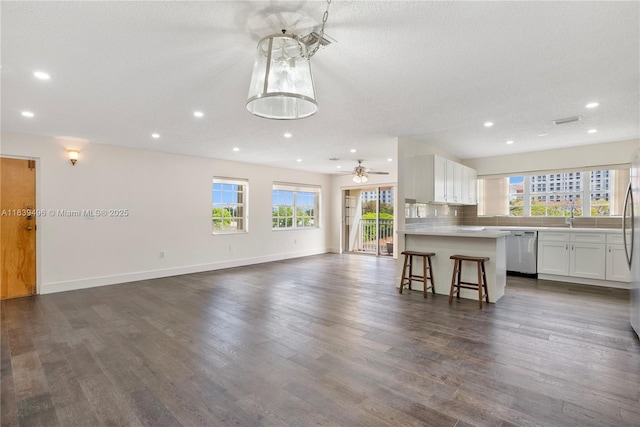 37 Majorca Ave Unit 401, Coral Gables, FL 33134 - kitchen featuring healthy amount of natural light, open floor plan, stainless steel dishwasher, recessed lighting, and white cabinets