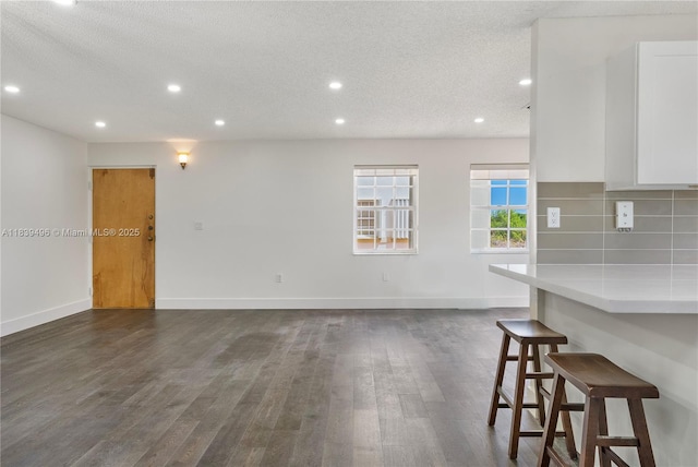 37 Majorca Ave Unit 401, Coral Gables, FL 33134 - unfurnished living room featuring dark wood-style flooring, recessed lighting, and a textured ceiling