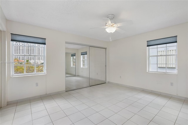 37 Majorca Ave Unit 401, Coral Gables, FL 33134 - unfurnished bedroom featuring a closet, a ceiling fan, and light tile patterned flooring