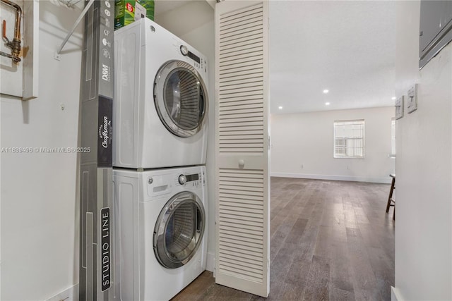 37 Majorca Ave Unit 401, Coral Gables, FL 33134 - laundry room featuring stacked washing machine and dryer, dark wood finished floors, and recessed lighting