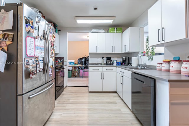 3991 NW 108th Ave, Coral Springs, FL 33065 - kitchen featuring freestanding refrigerator, dishwashing machine, white cabinets, and light wood-style flooring