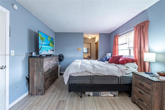 3991 NW 108th Ave, Coral Springs, FL 33065 - bedroom featuring a textured ceiling and light wood-style flooring
