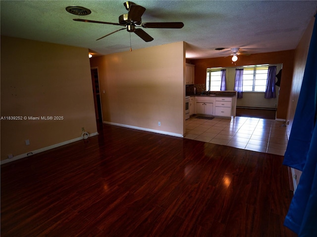 2918 NW 46th St, Tamarac, FL 33309 - unfurnished living room with a ceiling fan, a textured ceiling, and wood finished floors
