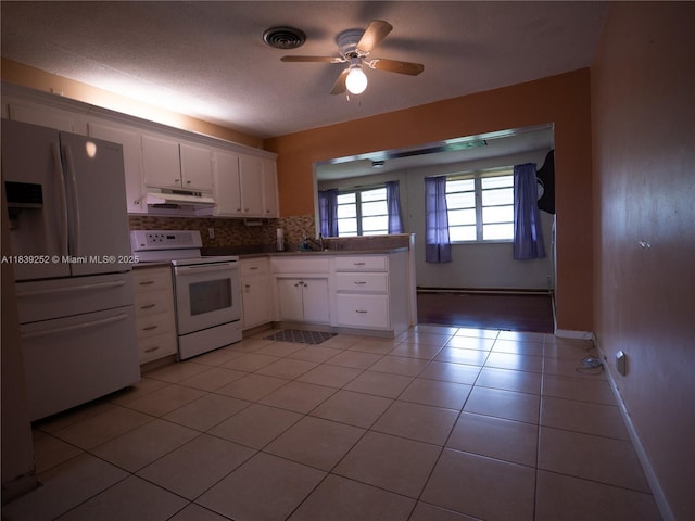 2918 NW 46th St, Tamarac, FL 33309 - kitchen with white appliances, under cabinet range hood, white cabinetry, decorative backsplash, and ceiling fan