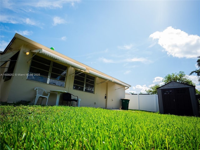 2918 NW 46th St, Tamarac, FL 33309 - rear view of house with a storage unit and stucco siding