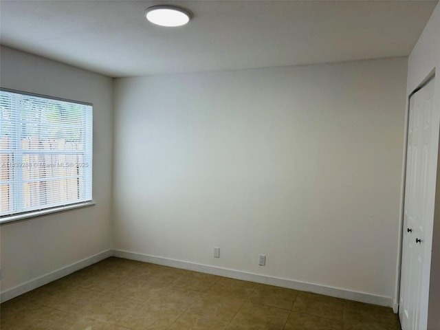 4710 NW 3rd Ter, Deerfield Beach, FL 33064 - unfurnished bedroom with a closet and light tile patterned floors
