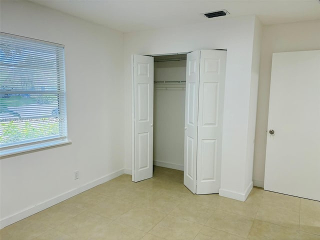 4710 NW 3rd Ter, Deerfield Beach, FL 33064 - unfurnished bedroom featuring light tile patterned floors and a closet