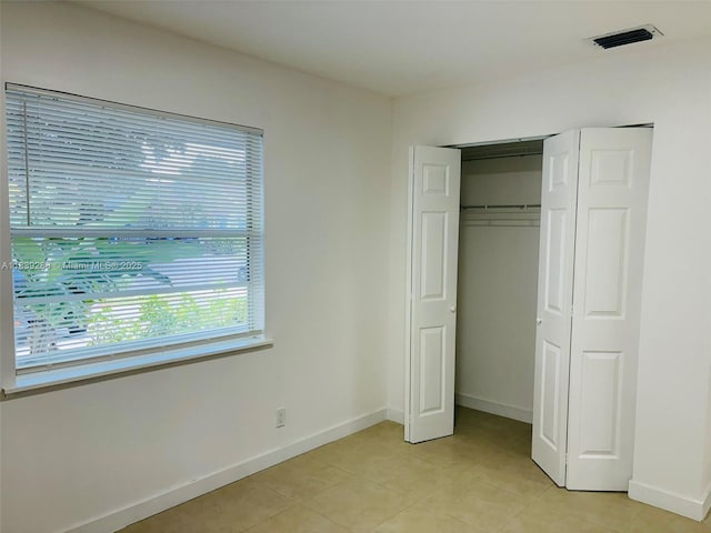 4710 NW 3rd Ter, Deerfield Beach, FL 33064 - unfurnished bedroom with light tile patterned floors and a closet