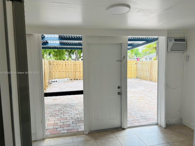 4710 NW 3rd Ter, Deerfield Beach, FL 33064 - doorway with a wall mounted air conditioner and tile patterned flooring