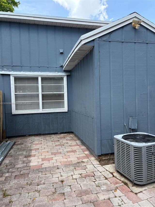 4710 NW 3rd Ter, Deerfield Beach, FL 33064 - view of side of home featuring a patio area and board and batten siding