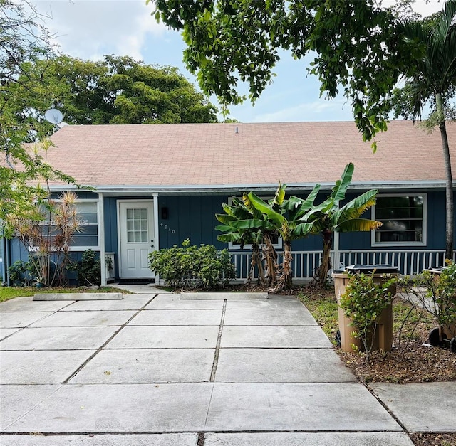 4710 NW 3rd Ter, Deerfield Beach, FL 33064 - view of front of house featuring roof with shingles and board and batten siding
