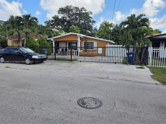 2936 NW 47th St, Miami, FL 33142 - view of front facade featuring a fenced front yard and a gate