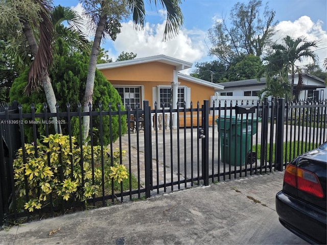 2936 NW 47th St, Miami, FL 33142 - view of front of house with stucco siding and a gate
