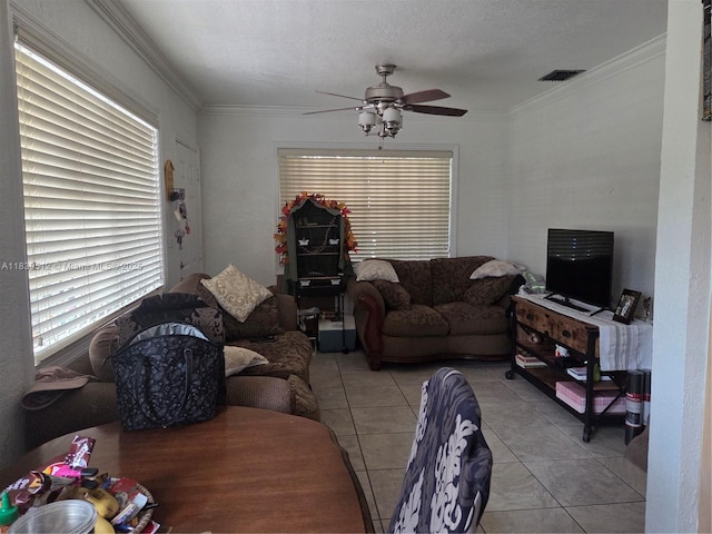 2936 NW 47th St, Miami, FL 33142 - living room featuring ceiling fan, tile patterned flooring, ornamental molding, and healthy amount of natural light