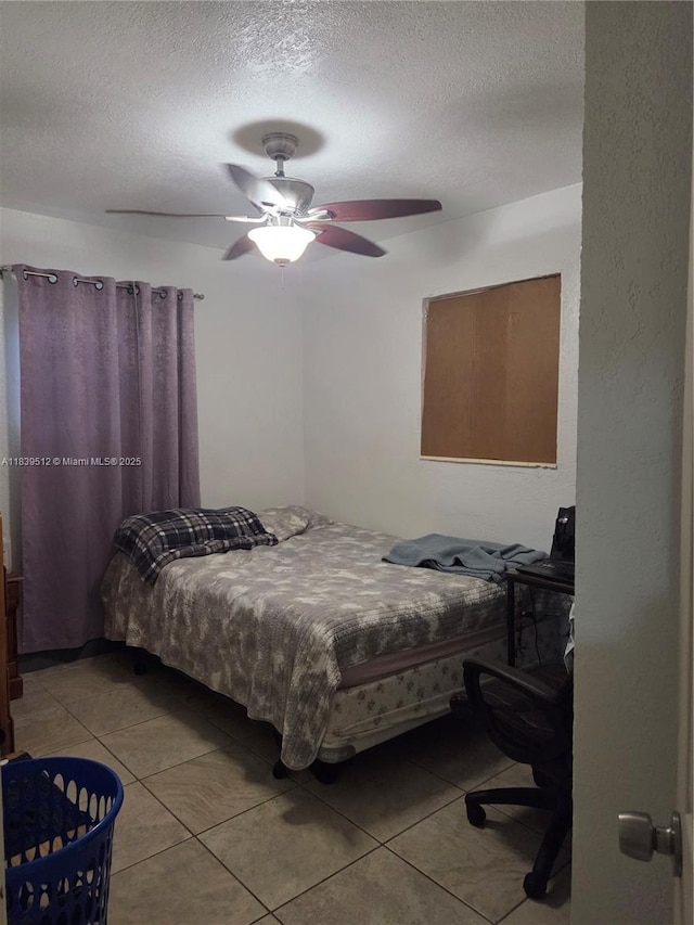 2936 NW 47th St, Miami, FL 33142 - bedroom featuring light tile patterned flooring, a textured ceiling, and ceiling fan