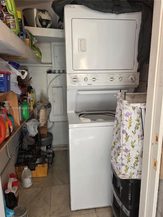 2936 NW 47th St, Miami, FL 33142 - washroom featuring stacked washing machine and dryer and light tile patterned floors