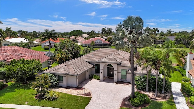 17809 Southwick Way, Boca Raton, FL 33498 - view of front of property with an attached garage, a tiled roof, stucco siding, a residential view, and decorative driveway