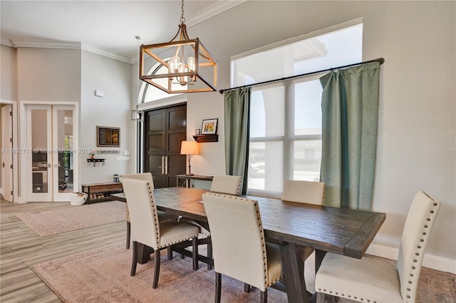 17809 Southwick Way, Boca Raton, FL 33498 - dining room with crown molding, a high ceiling, light wood-type flooring, and a chandelier