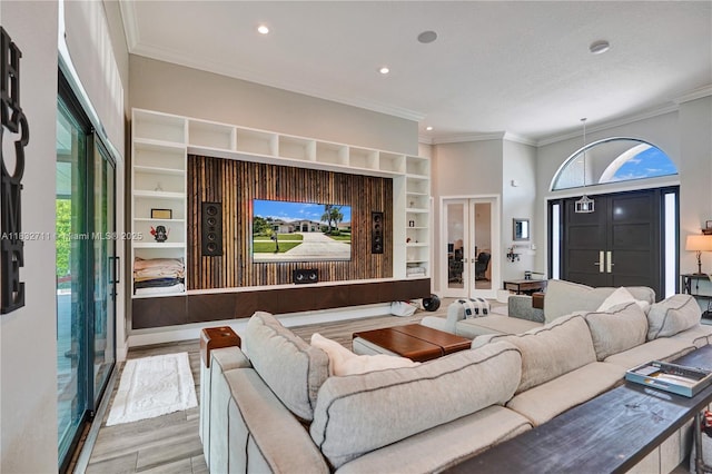 17809 Southwick Way, Boca Raton, FL 33498 - living area featuring french doors, wood finished floors, ornamental molding, built in features, and recessed lighting