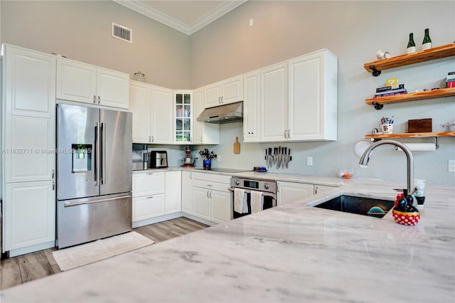 17809 Southwick Way, Boca Raton, FL 33498 - kitchen featuring stainless steel appliances, under cabinet range hood, crown molding, light stone countertops, and light wood-type flooring