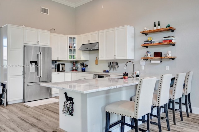 17809 Southwick Way, Boca Raton, FL 33498 - kitchen featuring high end refrigerator, under cabinet range hood, a peninsula, light stone countertops, and glass insert cabinets