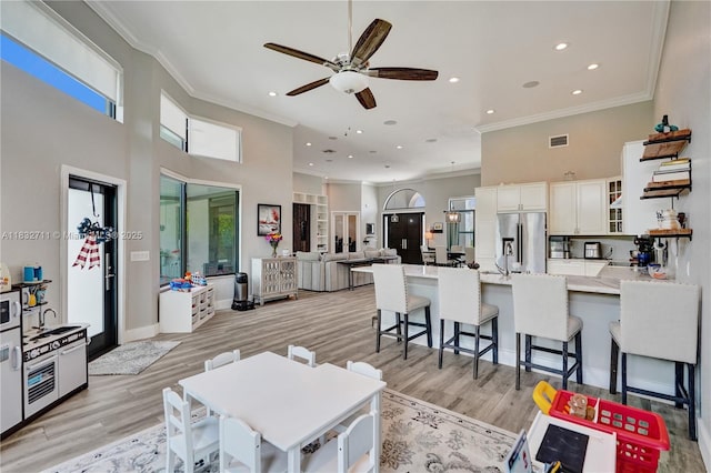 17809 Southwick Way, Boca Raton, FL 33498 - living room featuring light wood finished floors, crown molding, a high ceiling, ceiling fan, and recessed lighting