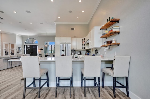 17809 Southwick Way, Boca Raton, FL 33498 - kitchen featuring stainless steel fridge, a peninsula, open shelves, ornamental molding, and light countertops