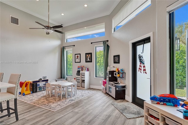17809 Southwick Way, Boca Raton, FL 33498 - game room featuring healthy amount of natural light, light wood-style flooring, ornamental molding, a high ceiling, and recessed lighting